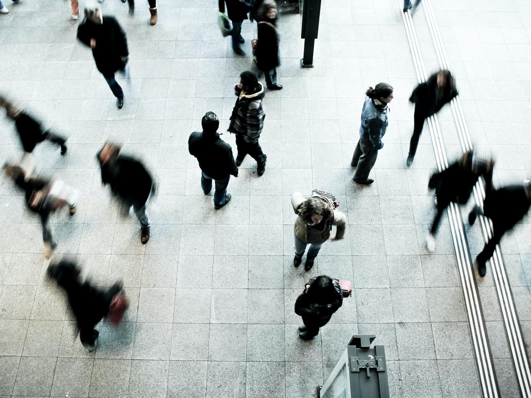 people walking on grey concrete floor during daytime